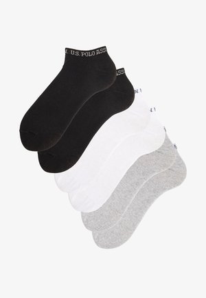 Calcetines hasta el tobillo en negro, blanco y gris. Hechos de un material suave con una textura lisa. Presentan el logo de U.S. Polo Assn. en los puños.