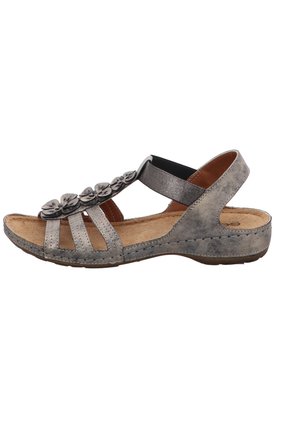 Gray sandal with a flat sole, featuring decorative flower accents, multiple straps, and an elastic back for support. Suede-like texture.