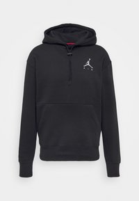 Felpa nera con cappuccio realizzata in tessuto morbido, presenta una tasca a canguro, cappuccio con coulisse e un logo Jumpman bianco sul petto. Vestibilità standard.