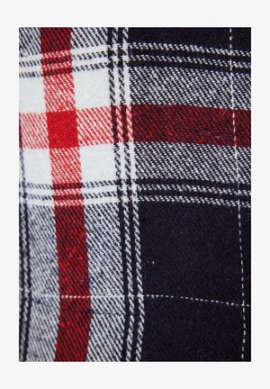 Tissu à carreaux présentant des couleurs bleu marine, rouge, blanc et gris. Motif à carreaux remarquable avec des lignes minces et contrastées et une texture douce.