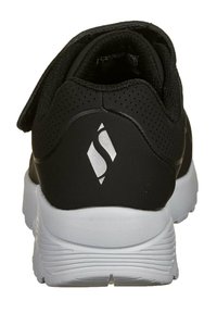 Scarpa sportiva nera con tomaia liscia, dettagli perforati, suola leggera bianca e logo in argento sul tallone. Chiusura con cinturino a strappo.