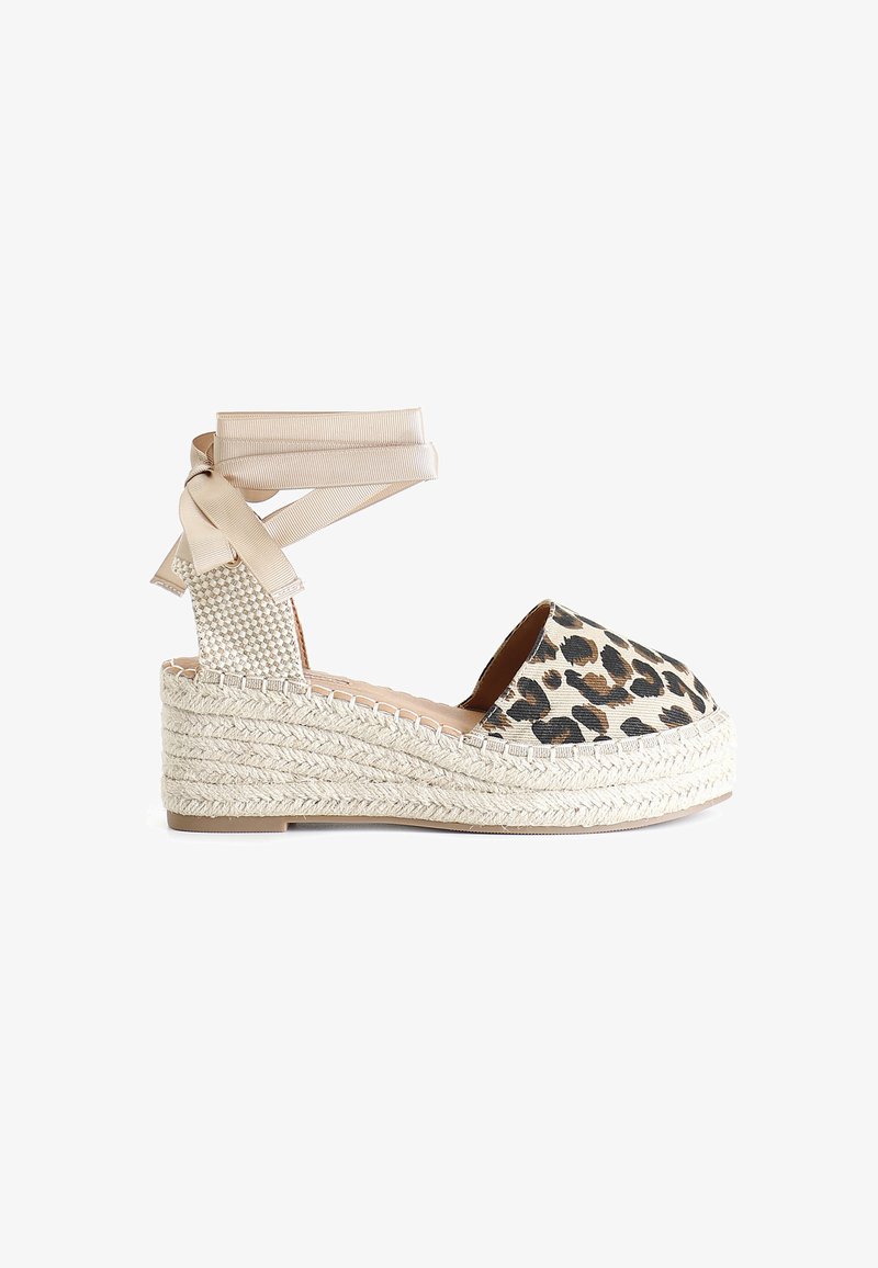 Leopard print wedge espadrille with a round toe, braided jute sole, and beige ribbon ankle ties, featuring textured heel accents.