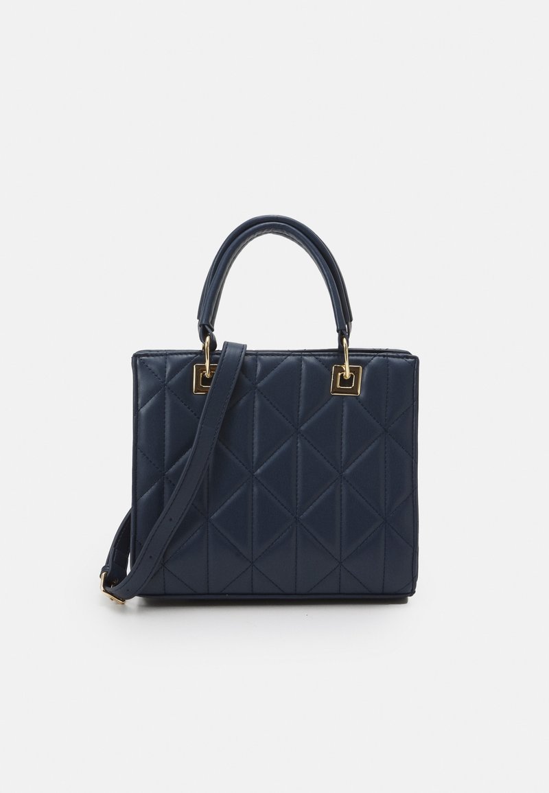 Sac à main matelassé bleu marine avec anses hautes et bandoulière amovible, agrémenté d’accents en métal carré doré.