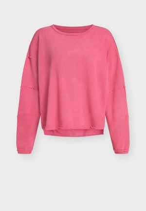 Ružová mikina s dlhým rukávom z textúrovaného materiálu, voľného strihu, s okrúhlym výstrihom a ošúchanými okrajmi na rukávoch a spodnej časti.