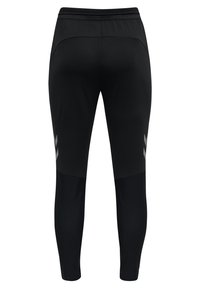 Schwarze Sporthose mit schmaler Passform. Mit einem strukturierten Bund, Netzeinsätzen an den Unterschenkeln und zwei reflektierenden Chevron-Mustern an den Seiten.