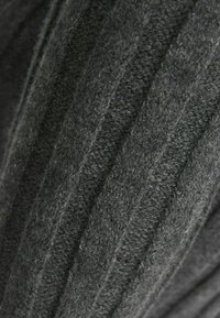 Dark gray knitted fabric with a soft, textured pattern of diagonal ridges and loops.