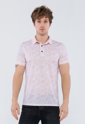 Camisa polo en rosa claro con patrón texturizado, mangas cortas y un cuello en contraste. Tapeta de tres botones con botones oscuros.