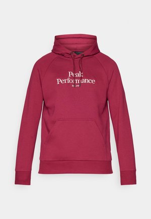 Bordeauxroter Kapuzenpullover mit Kängurutasche, gerippten Bündchen und Saum. Mit dem weißen "Peak Performance"-Logo auf der Vorderseite.