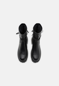 Black leather ankle boots with a smooth surface, round toe, and textured rubber sole. Features adjustable laces and a pull tab for ease of wear.