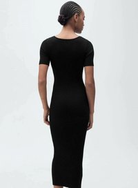 Black ribbed midi dress with short sleeves and a fitted silhouette, featuring a round neckline and textured fabric.