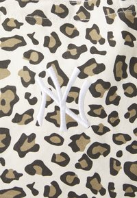 Leopard print fabric with beige and black patterns; features a white embroidered "NY" logo. Textured, durable cotton material.