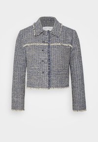 Krossad blå och vit tweedjacka med fransade kanter, en krage och svarta knappar. Strukturerad väv med horisontella ränder och en formad design.