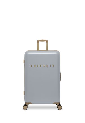 Light grey hard-shell suitcase with four wheels, telescopic handle, and gold "SUITSUIT" logo on front.
