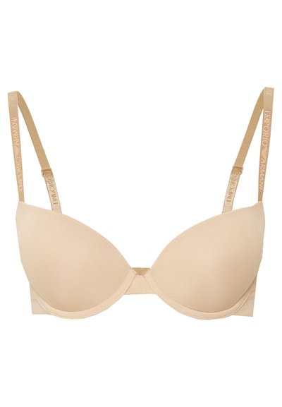 Beige gewatteerde beha met verstelbare bandjes, onderwired ondersteuning, een zachte textuur en logodetails op de bandjes, met een naadloos ontwerp.