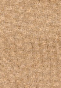 Tessuto lavorato a maglia in un morbido e caldo colore beige con un motivo testurizzato; tessuto in modo uniforme con sottili variazioni di tonalità.