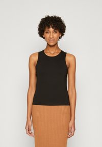 Schwarzes ärmelloses Oberteil mit rundem Halsausschnitt, aus glattem Stoff gefertigt. Verfügt über ein eng anliegendes Design und einen minimalistischen Stil.