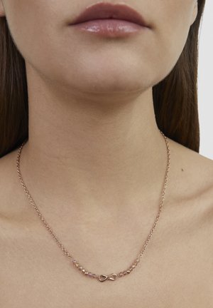 Halskette aus Roségold mit einem Unendlichkeitssymbol als Mittelstück, umgeben von kleinen, facettierten Perlen in Rosa- und Klar-Tönen, an einer filigranen Kette.