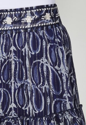 Navy blue skirt with a patterned design featuring light blue swirls and stripes. The waistband is adorned with embroidered floral accents.