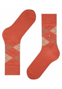 Calze arancioni con motivo argyle in beige e tonalità più scure, con un polsino a costine e un piccolo dettaglio in argento.