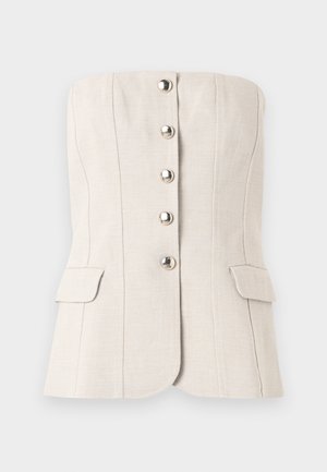 Haut beige sans bretelles, cintré, avec boutons métalliques à l'avant et deux poches à rabat à la taille, structuré par des coutures verticales.