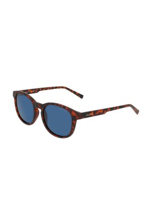 Lunettes de soleil en écaille de tortue avec verres ronds bleus et branches fines arborant le logo Nautica sur les côtés.