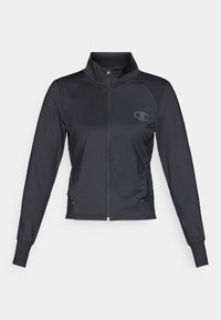 Černá sportovní bunda se zipem vpředu, vysokým límcem, dlouhými rukávy a žebrovanými detaily na ramenech. Na hrudi se nachází logo.