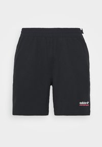 Pantaloni corti neri in cotone con vita elasticizzata, con ricamo bianco e rosa "adidas ADVENTURE" sul lato destro in basso.