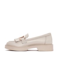 Mocassins en cuir beige avec un bout arrondi, semelle en caoutchouc plate et une boucle décorative sur le devant. Design épuré avec un minimum de coutures.