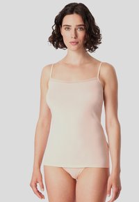 Light pink camisole with thin straps, smooth texture, lace trim along the neckline, and fitted design, paired with matching briefs.