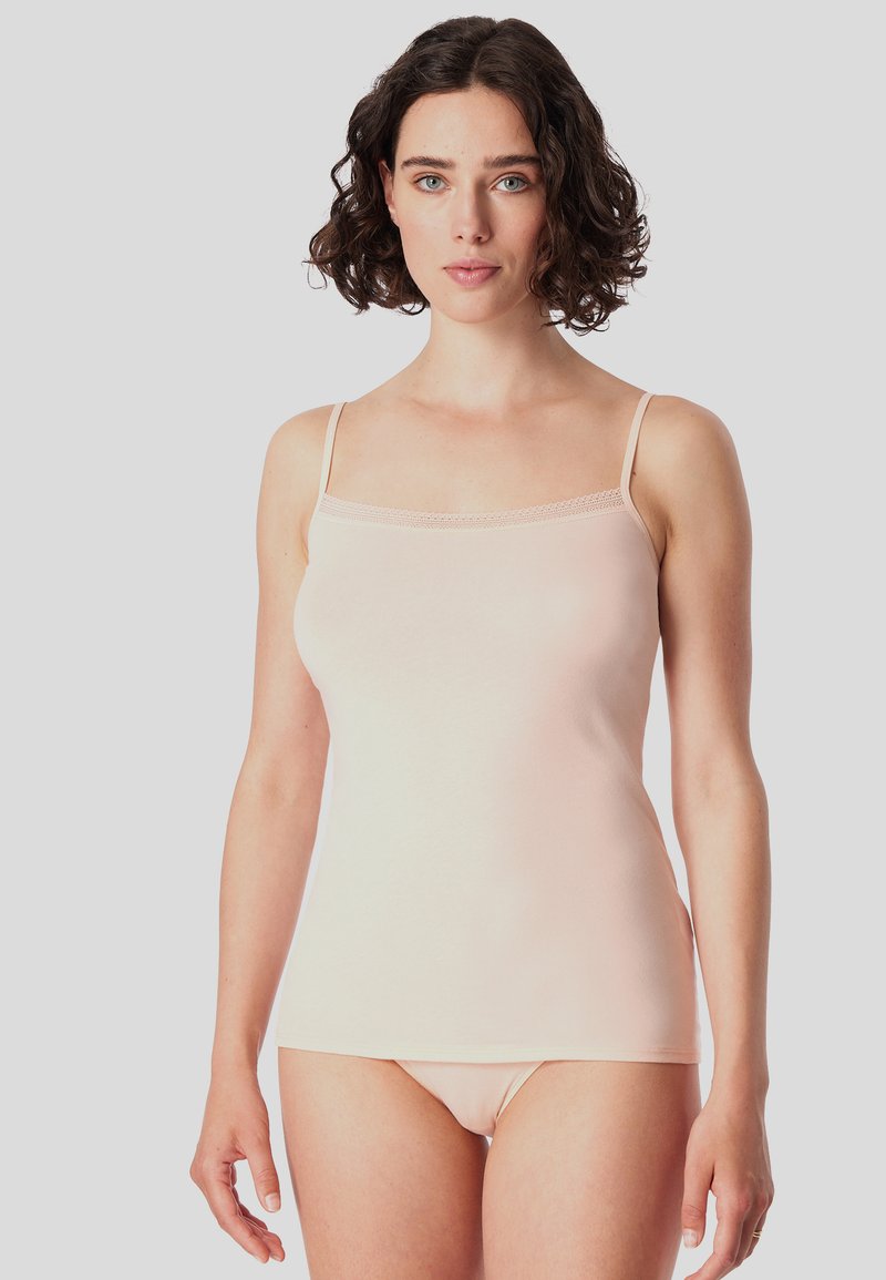 Light pink camisole with thin straps, smooth texture, lace trim along the neckline, and fitted design, paired with matching briefs.