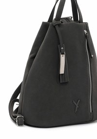 Perforated dark gray backpack with a triangular shape, silver hardware, a zipper closure, and a tassel accent. Adjustable strap included.