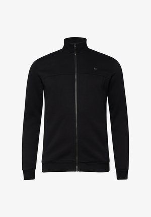 Zwarte jas met volledige ritssluiting, opstaande kraag, geribde manchetten en zoom, en een subtiel logo op de linkerborst.