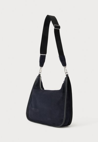 Dark blue suede shoulder bag with black adjustable wide strap and silver metal zipper and clasps, shown against a plain light background.