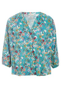 Blouse florale turquoise avec décolleté en V, manches trois-quarts et coupe ample. Présente des motifs colorés de fleurs et de feuilles sur l'ensemble.