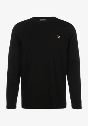 Camiseta negra de manga larga con cuello redondo y pequeño logo de pájaro amarillo en el pecho izquierdo.