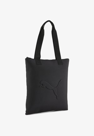 Schwarze Tragetasche aus weichem Material, ausgestattet mit einem Reißverschluss und einem geprägten Logo auf der Vorderseite. Die Tasche hat zwei Stofftrageriemen.