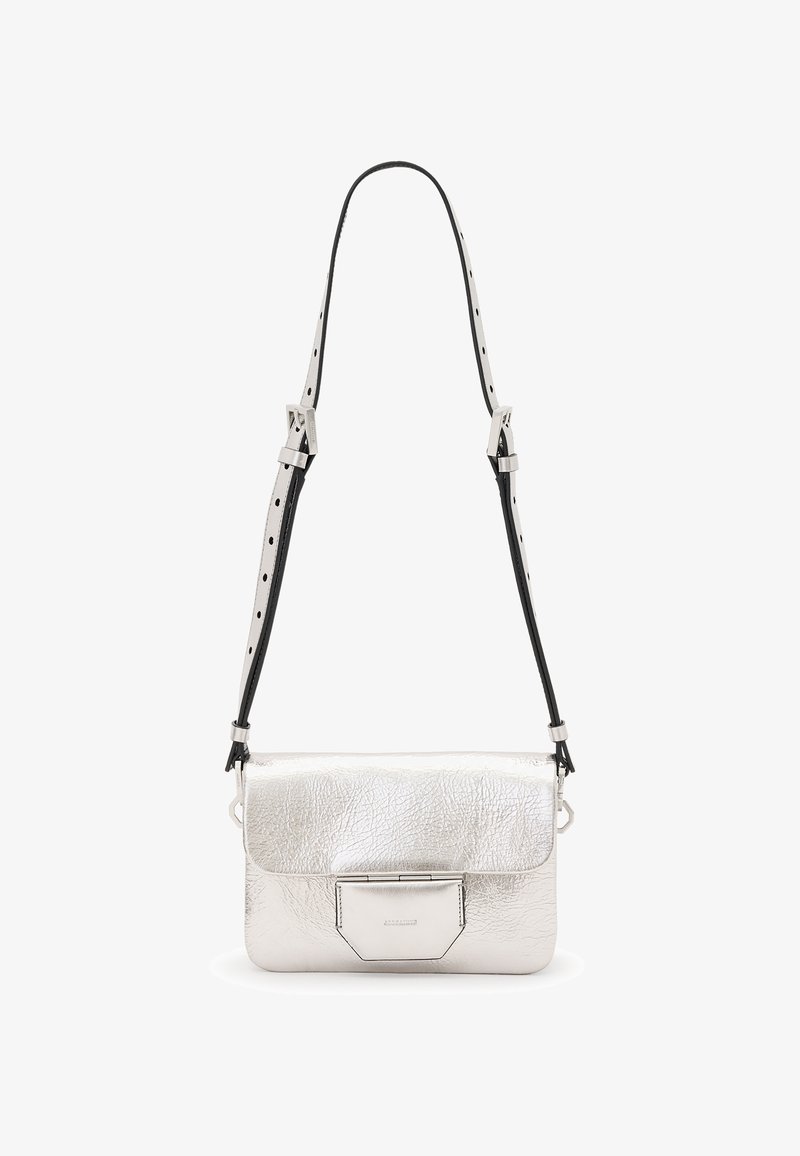 Silver metallic leather crossbody bag with a textured finish, fold-over flap, and adjustable black and white strap. Minimalist design.