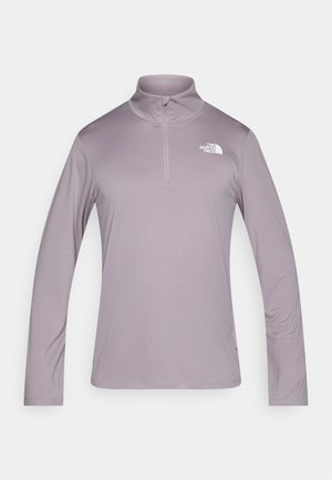 Lila Langarm-Pullover mit hohem Kragen und Reißverschluss vorne. Weicher, glatter Stoff mit kleinem weißem Logo auf der oberen linken Brust.