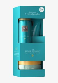 Set aus drei türkisfarbenen Hautpflegeprodukten in einer passenden Schachtel. Verziert mit goldenen Akzenten und gemusterten Etiketten, beschriftet mit "The Ritual of Karma".