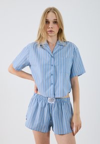Blue striped short-sleeve shirt and matching shorts. Lightweight fabric, buttons down front, pocket on shirt, elastic waistband on shorts.