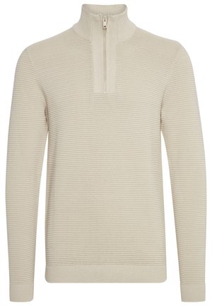 Beiger Strickpullover mit hohem Kragen und halbseitigem Reißverschluss. Gerippte Struktur, lange Ärmel und enge Bündchen. Sauberes, minimalistisches Design.