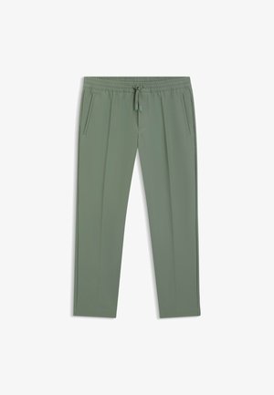 Green athletic pants made of lightweight fabric, featuring two side pockets, an elastic waistband, and a drawstring for adjustment.