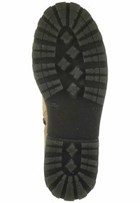 Suola di stivale in gomma con battistrada profondo e robusto, di forma ovale, realizzata in materiale nero e con intricati schemi di aderenza per stabilità.