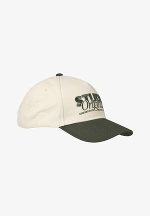 Beige audinio beisbolo kepurė su tamsiai žaliu vizoriumi. Yra išsiuvinėtas tekstas ir reguliuojama galinė dirželio juosta, kad būtų patogu nešioti.