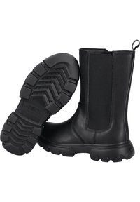 Botas de tobillo negras de cuero suave con paneles laterales elásticos y una suela de goma texturizada con un patrón de banda de rodadura en zigzag.