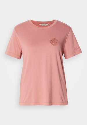 Camiseta de algodón rosa con cuello redondo, mangas cortas, patrón circular bordado en el pecho y acento de nombre de marca en la manga.
