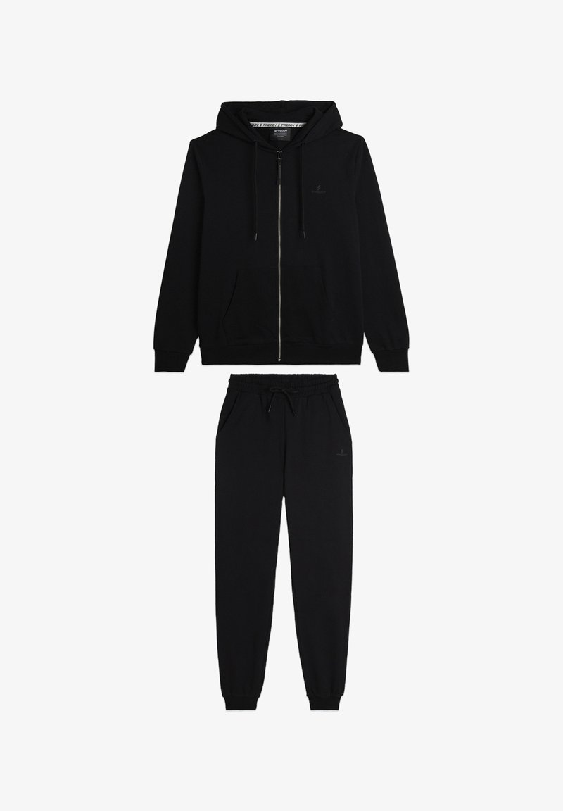 Sudadera con cremallera negra y pantalones de chándal a juego. Tejido suave, cintura con cordón, piernas ajustadas, branding mínimo visible.