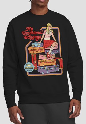 Person wearing black sweatshirt with cartoon girl in red skirt sitting on colorful suitcases and text "My Emotional Baggage" and "Life Skills Series."