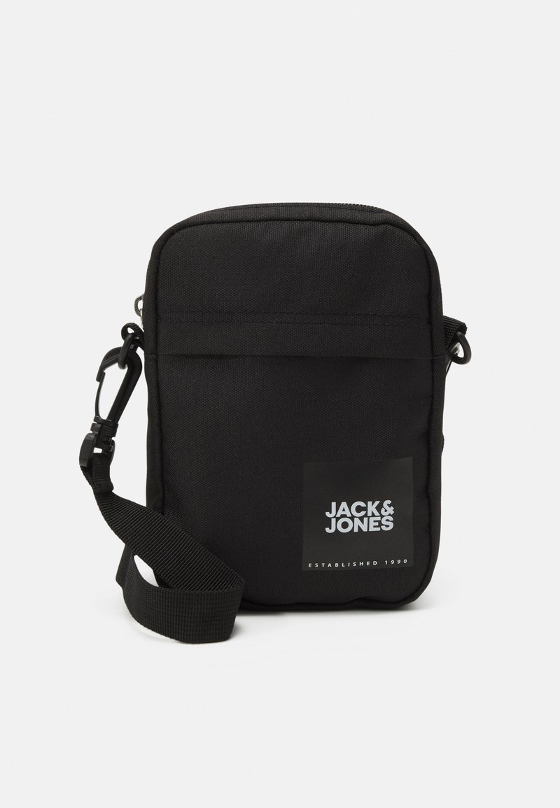 Black crossbody bag made from durable fabric. Features a front pocket, adjustable strap, and a logo patch with "JACK & JONES."