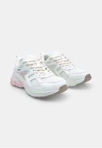 White athletic shoes with mesh panels, beige accents, and a textured rubber sole. Features laces and a padded collar for comfort.